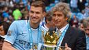 Edin Dzeko. Striker Bosnia berusia 36 tahun yang sejak musim 2021/2022 memperkuat Inter Milan ini menjadi pemain Bosnia tersukses di liga top Eropa dengan menjuarai dua liga berbeda, yaitu Liga Jerman dan Liga Inggris. Liga Jerman dijuarainya saat memperkuat Wolfsburg bersama Zvjezdan Misimovic pada musim 2008/2009. Sementara gelar Liga Inggris dirahnya bersama Manchester City sebanyak 2 kali pada musim 2011/2012 dan 2013/2014. (AFP/Andrew Yates)