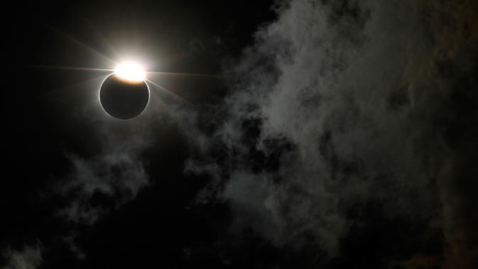 Gerhana matahari parsial terlihat di atas Gateway Arch, Missouri, Senin (21/8). Gerhana Matahari Total tahun ini membuat gelap sebagian wilayah Amerika Serikat yang dilintasi oleh bayangan Bulan. (AP Photo/Jeff Roberson)