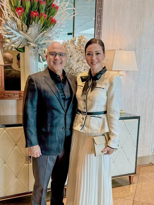 Tampilan elegan Maia Estianty rayakan Tahun Baru 2024 di California. Ia tampil menawan dengan tweed blazer dan rok plisket serba broken white, dipermanis dengan belt dan dasi pita berwarna hitam. [@maiaestiantyreal]