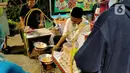 Penjual Kerak Telor menyiapkan pesanan pembeli selama Festival #IniJakarta 2022 di kawasan Kota Tua, Jakarta, Sabtu (17/9/2022). Berbagai makanan dan minuman dijajakan dalam program #TemuRasaKarya. (Liputan6.com/Magang/Aida Nuralifa)