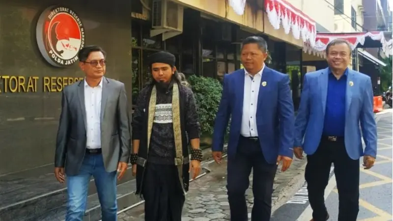 Samsudin (baju hitam) bersama kuasa hukumnya di Polda Jatim. (Dian Kurniawan/Liputan6.com).