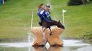 Atlet berkuda Rusia, Mikhail Nastenko, terjatuh saat melewati rintangan di nomor cross country Kejuaraan Eropa FEI di Blair Castle, Skotlandia. Sabtu (12/9/2015). (Reuters/Russell Cheyne)