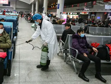 Petugas menyemprotkan cairan disinfektan di Stasiun Kereta Api Yingtan di Nanchang di Provinsi Jiangxi Tengah, China (22/1/2020). Penyemprotan dilakukan untuk mencegah virus corona menyebar ke kota lain. (AFP Photo/STR)