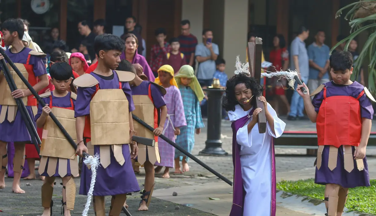Anak-anak umat Katolik memeragakan drama penyaliban Yesus Kristus dalam Tablo Jalan Salib di Gereja Santo Stefanus, Cilandak, Jakarta Selatan, Jumat (18/4/2025). (merdeka.com/Arie Basuki)