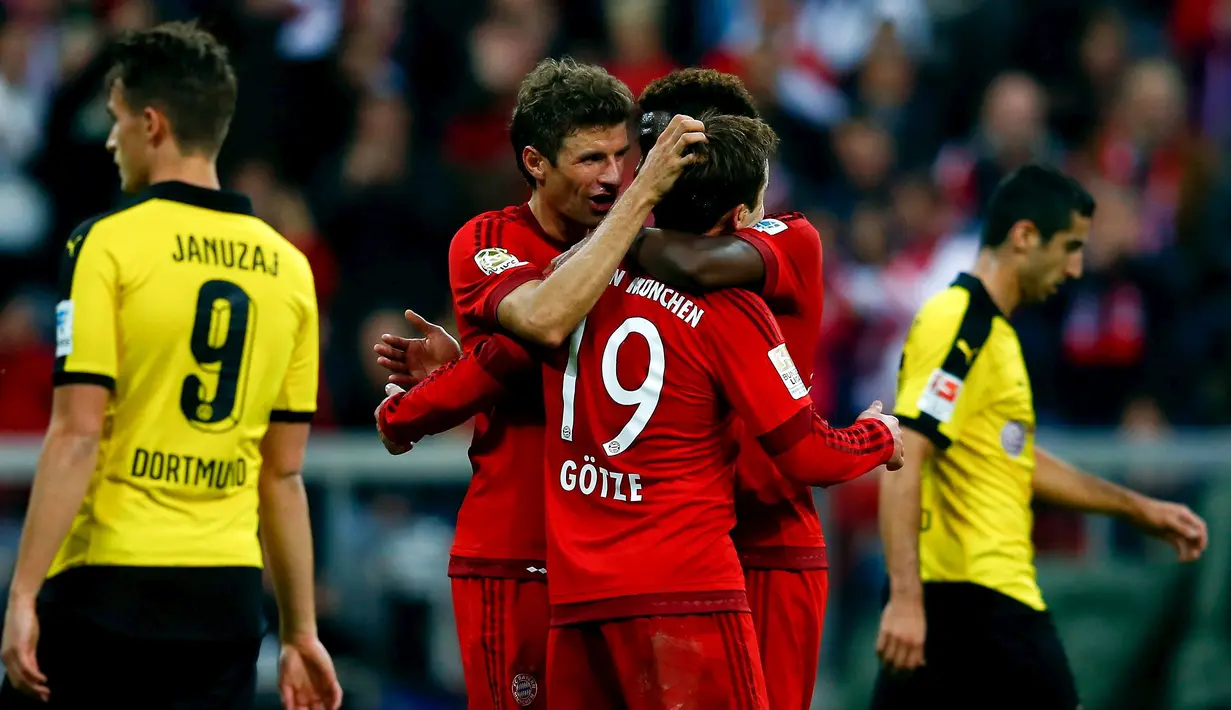 Thomas Mueller, Mario Goetze and David Alaba merayakan gol saat berjumpa Borussia Dortmund  dalam lanjutan Bundesliga di Stadion Allianz Arena, Muenchen, Minggu (4/10/2015). Muenchen menang telak 5-1 atas Dortmund.(REUTERS/Michael Dalder)