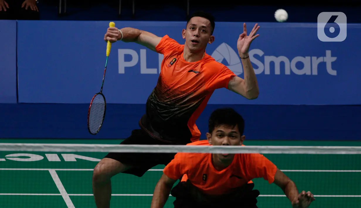 Ganda putra Indonesia, Fajar Alfian/Muhammad Rian Ardianto mengembalikan kok ke arah pasangan Malaysia, Aarron Chia/Soh Wooi Yik pada final bulutangkis beregu putra SEA Games 2019 di Multinlupa Sport Center, Rabu (4/12/2019). Fajar / Rian kalah 17-21 dan 13-21. (Bola.com/M Iqbal Ichsan)