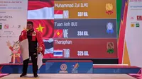 Lifter asal Aceh, Muhammad Zul Ilmi, berhasil mempersembahkan medali emas SEA Games 2021 untuk Indonesia dari cabang olahraga angkat besi di nomor 89 kg men's di Hanoi Sports Training and Competition Center, Hanoi, Minggu (22/5/2022) siang waktu setempat. (Bola.com/Muhammad Adiyaksa)