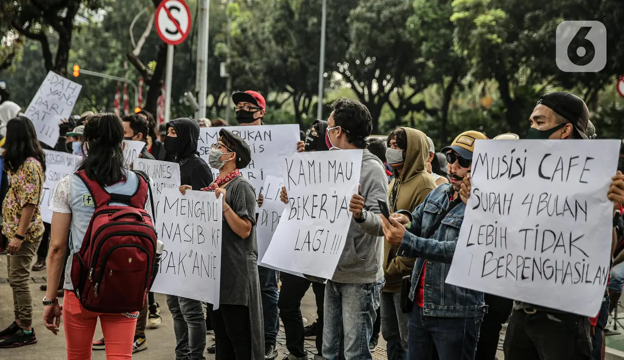 Sejumlah musisi kafe saat melaksanakan aksi di depan Balai Kota Jakarta, Rabu (8/7/2020). Aksi ngamen di depan Balai Kota Jakarta yang diikuti oleh musisi kafe itu untuk menyuarakan aspirasi pekerja seni harian yang terdampak mata pencahariannya selama masa PSBB. (Liputan6.com/Faizal Fanani)