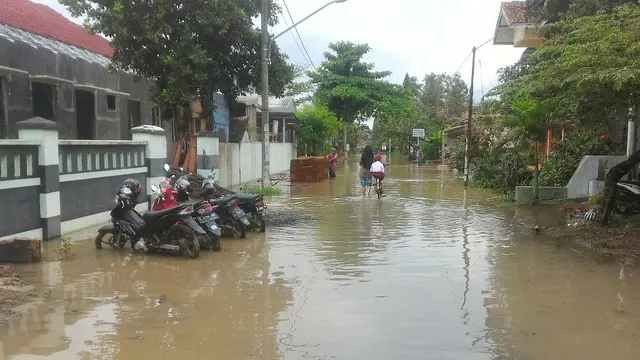 Seorang ibu menjemput anaknya dari sekolah di Dusun Cibenon Desa Sidareja Kecamatan Sidareja, Cilacap. (Foto: Liputan6.com/Muhamad Ridlo)