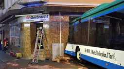 Kondisi bus yang menabrak tembok sebuah toko di Eberbach dekat Mannheim, Jerman, Selasa (16/1). Kecelakaan terjadi sekitar pukul 7:00 pagi waktu setempat saat bus dalam perjalanan ke sebuah sekolah di kota barat daya Eberbach. (Rene Priebe/dpa via AP)