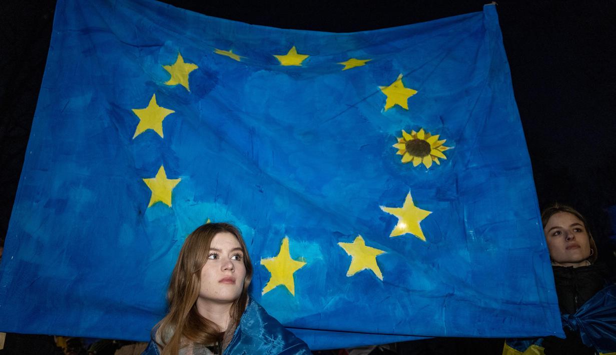 Warga Polandia dan anggota diaspora Ukraina ikut serta dalam demonstrasi di depan Kedutaan Besar Ukraina di Warsawa untuk memperingati tahun ketiga invasi Rusia ke Ukraina pada 24 Februari 2025. (Wojtek RADWANSKI/AFP)