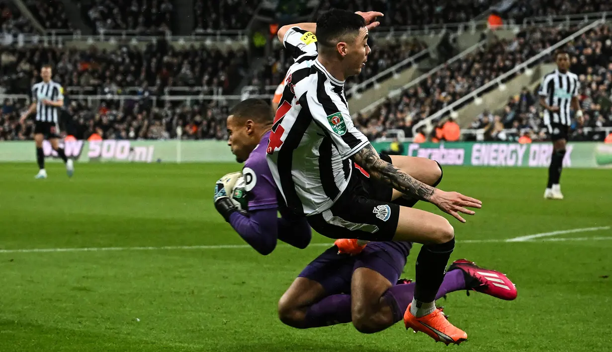 Pemain Newcastle, Miguel Almiron (kanan) berebut bola dengan kiper Southampton Gavin Bazunu pada laga semifinal Carabao Cup 2022/2023 yang berlangsung di St James Park, Rabu (1/2/2023) WIB. The Magpies berhasil menang dengan skor 2-1. (AFP/Paul Ellis)