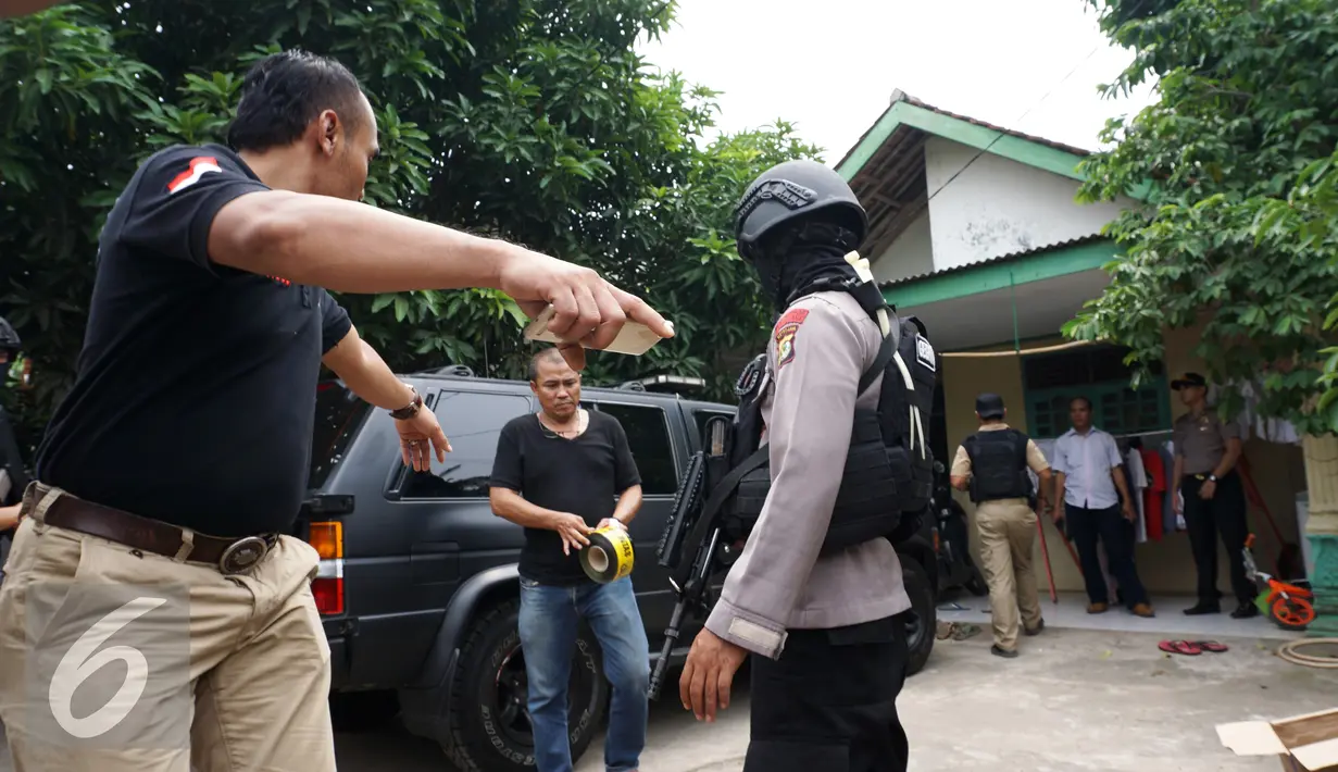 Rumah orangtua SA, pelaku penusukan tiga anggota polisi, di Kelurahan Sepatan, Tangerang, digeledah polisi Kamis (20/10). Polisi mengambil sejumlah barang terkait penyerangan di Pospol Cikokol yang melukai tiga anggota polisi. (Liputan6.com/Stringer)