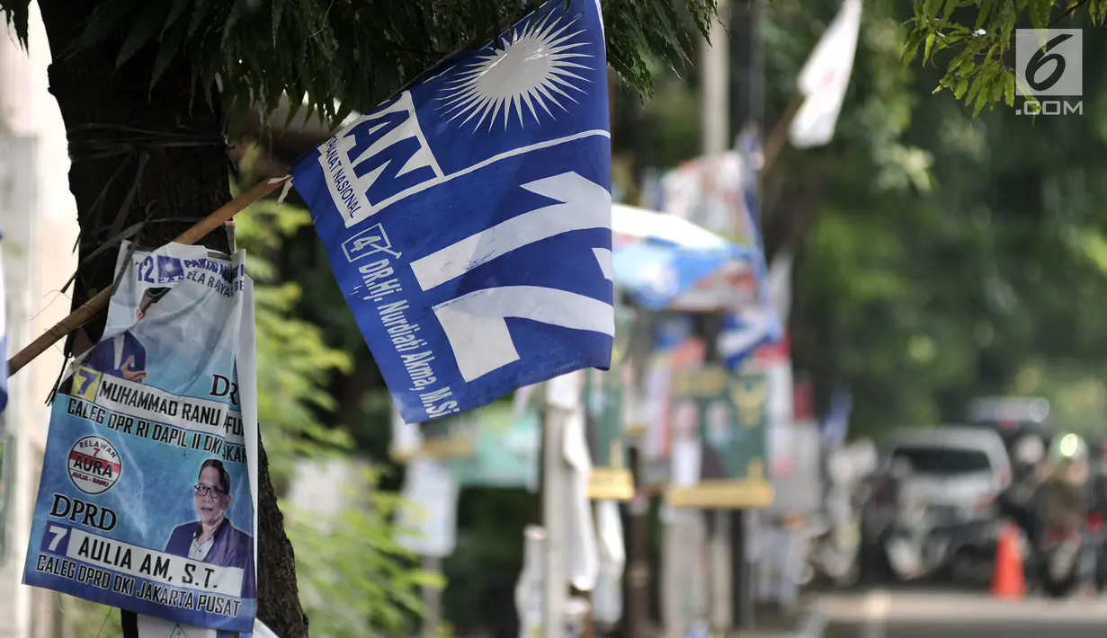 Alat peraga kampanye (APK) calon anggota legislatif (caleg) memenuhi pepohonan yang berada di pinggir jalan, Jakarta, Rabu (20/3). Pemasangan APK caleg tersebut juga dapat merusak pepohonan serta lingkungan. (merdeka.com/Iqbal Nugroho)