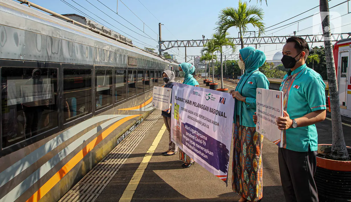 Petugas memberikan salam kepada penumpang saat KA Taksaka berangkat dari Stasiun Gambir, Jakarta, Sabtu (4/8/2021). Dalam rangka memperingati hari pelanggan nasional, PT KAI Daop 1 Jakarta membagikan ratusan bingkisan kepada penumpang kereta api. (Liputan6.com/Faizal Fanani)